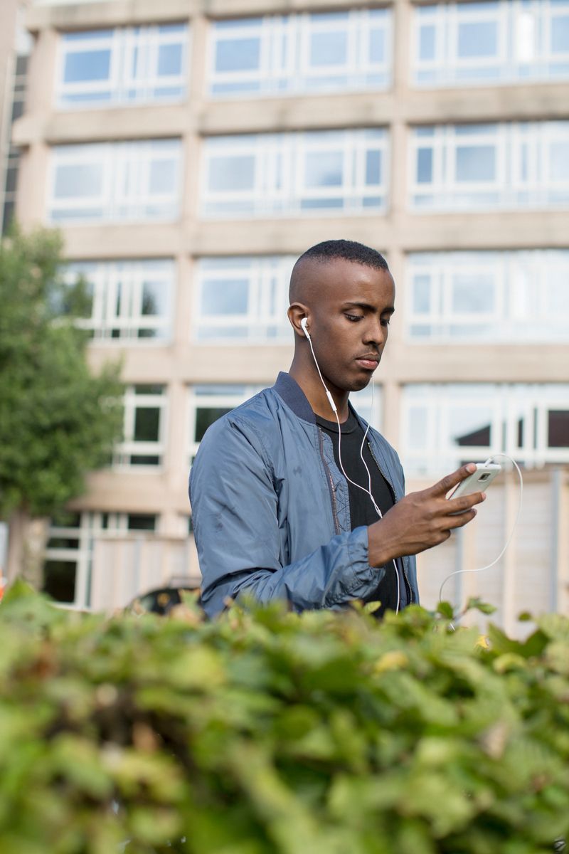 An employee with a phone and earphones on a break