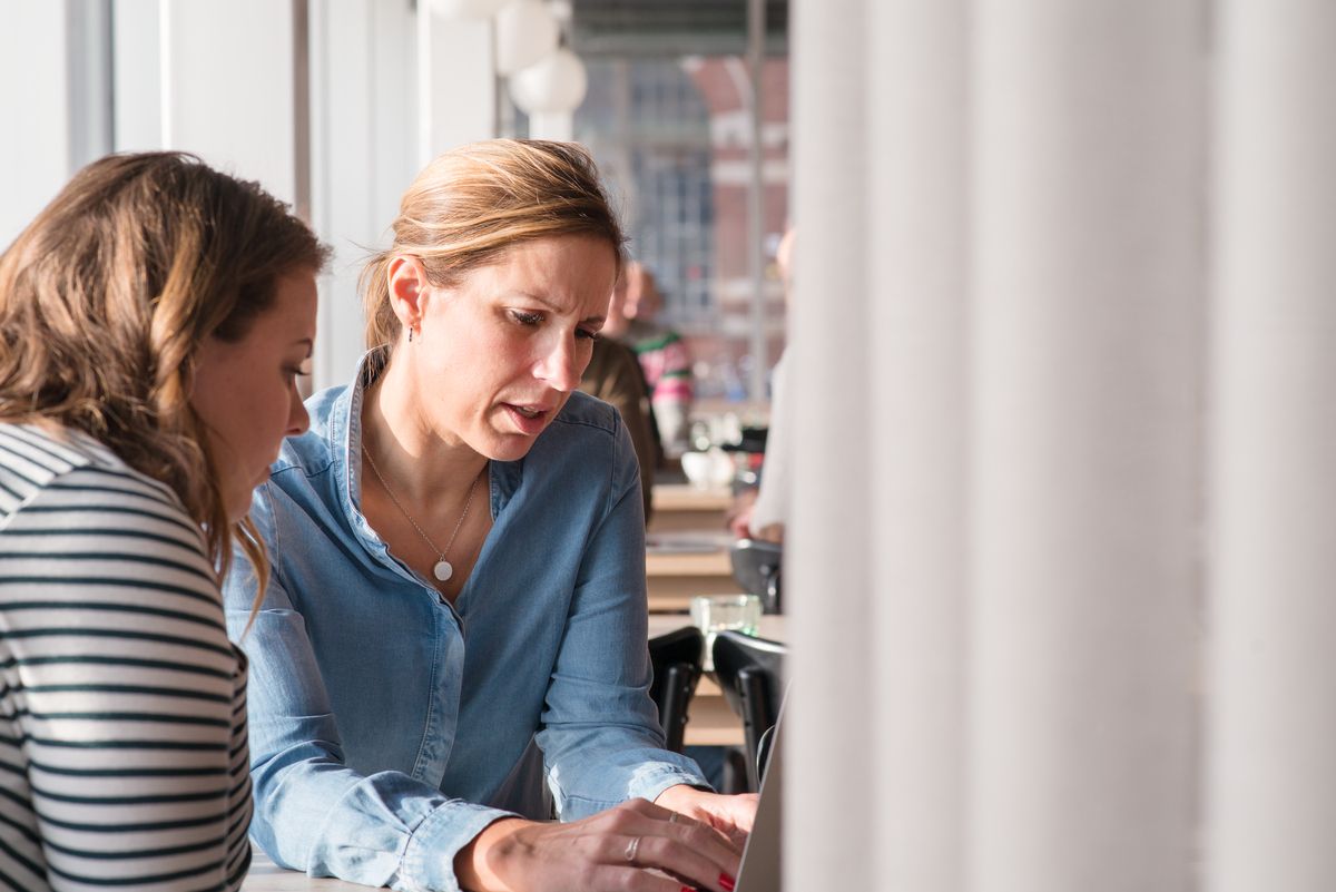 A frustrated customer leaning towards the member of staff