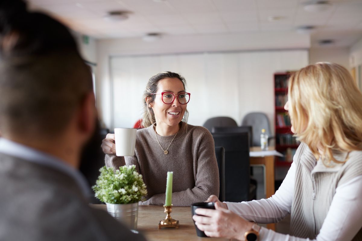 Colleagues at a school talking around a table