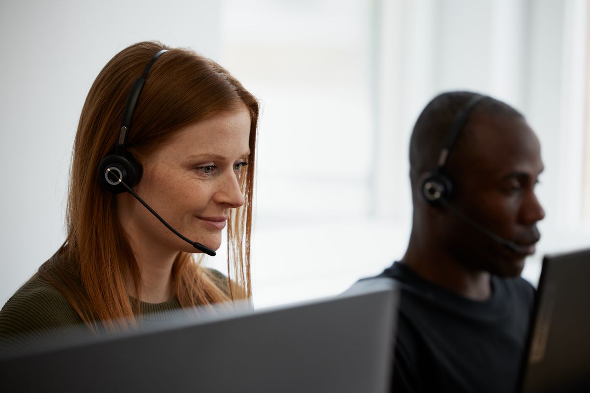 Staff with headsets at a screen