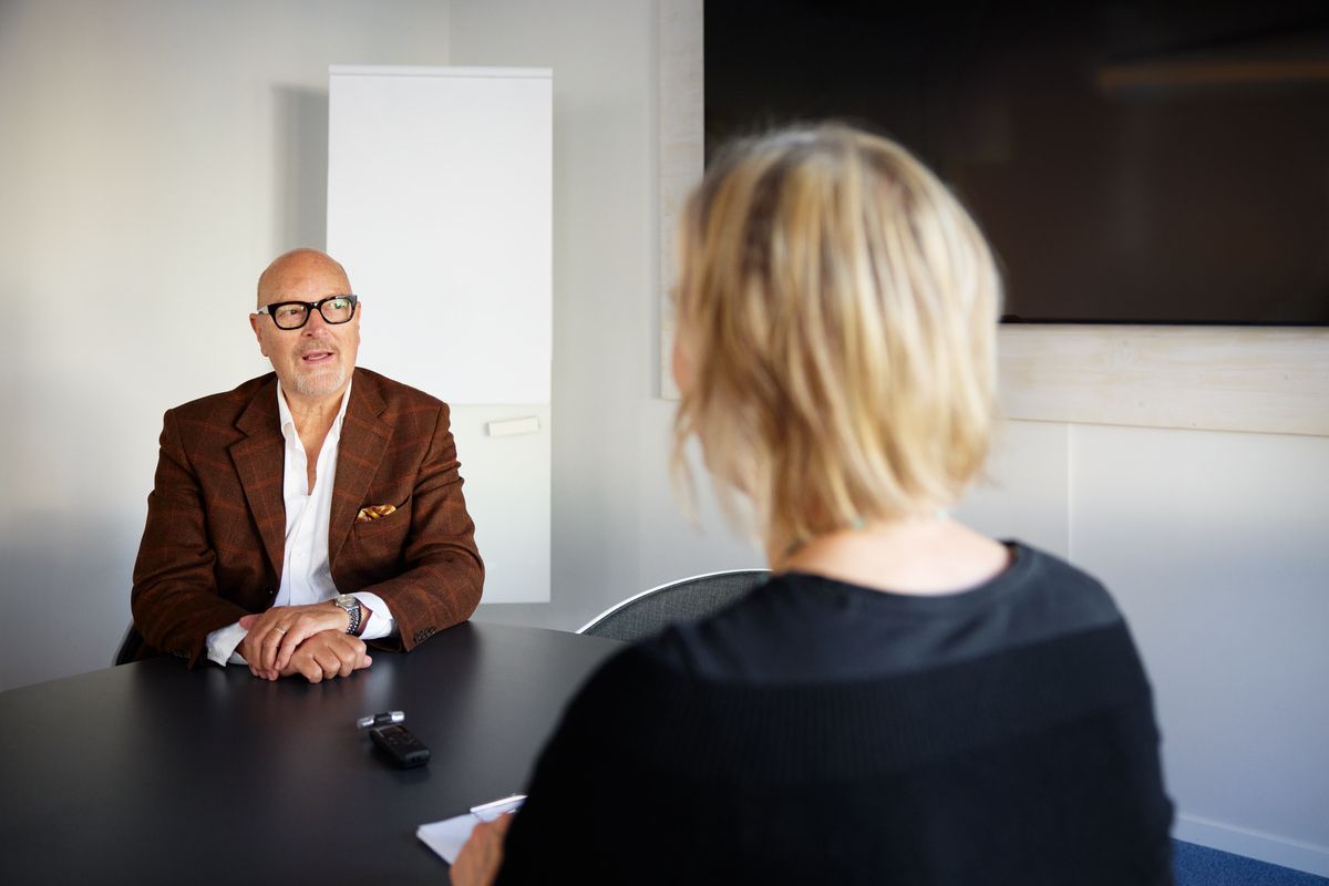 A manager and an employee talking in a meeting room