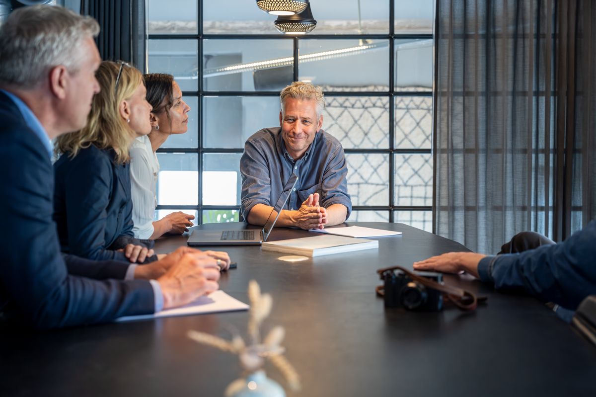 A meeting around a table where several people have to decide